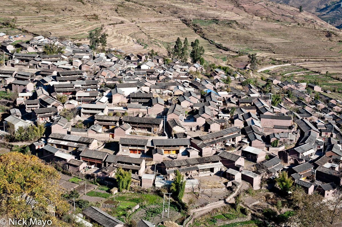 The mud brick Lama Bai village of Shin Hwa with its grey tiled roofs.