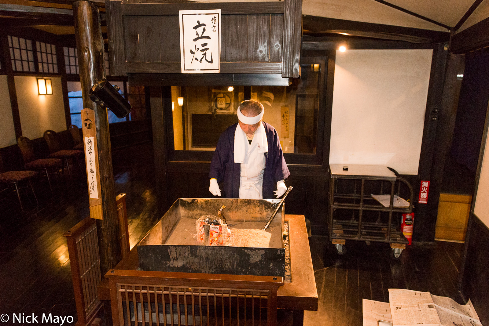 Cooking fish on a hearth at Ryugon ryokan in Muikamachi.