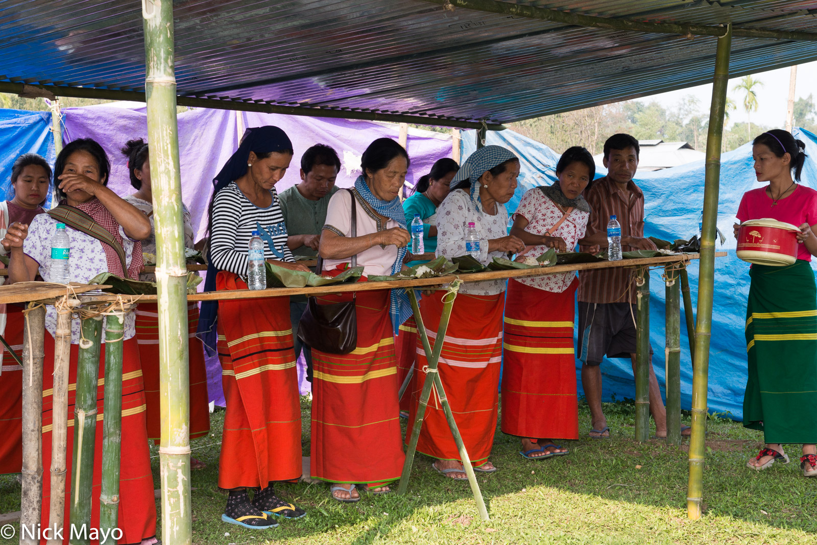 Adi Padam women eating lunch in the traditional manner at a harvest celebration in Siluk village.