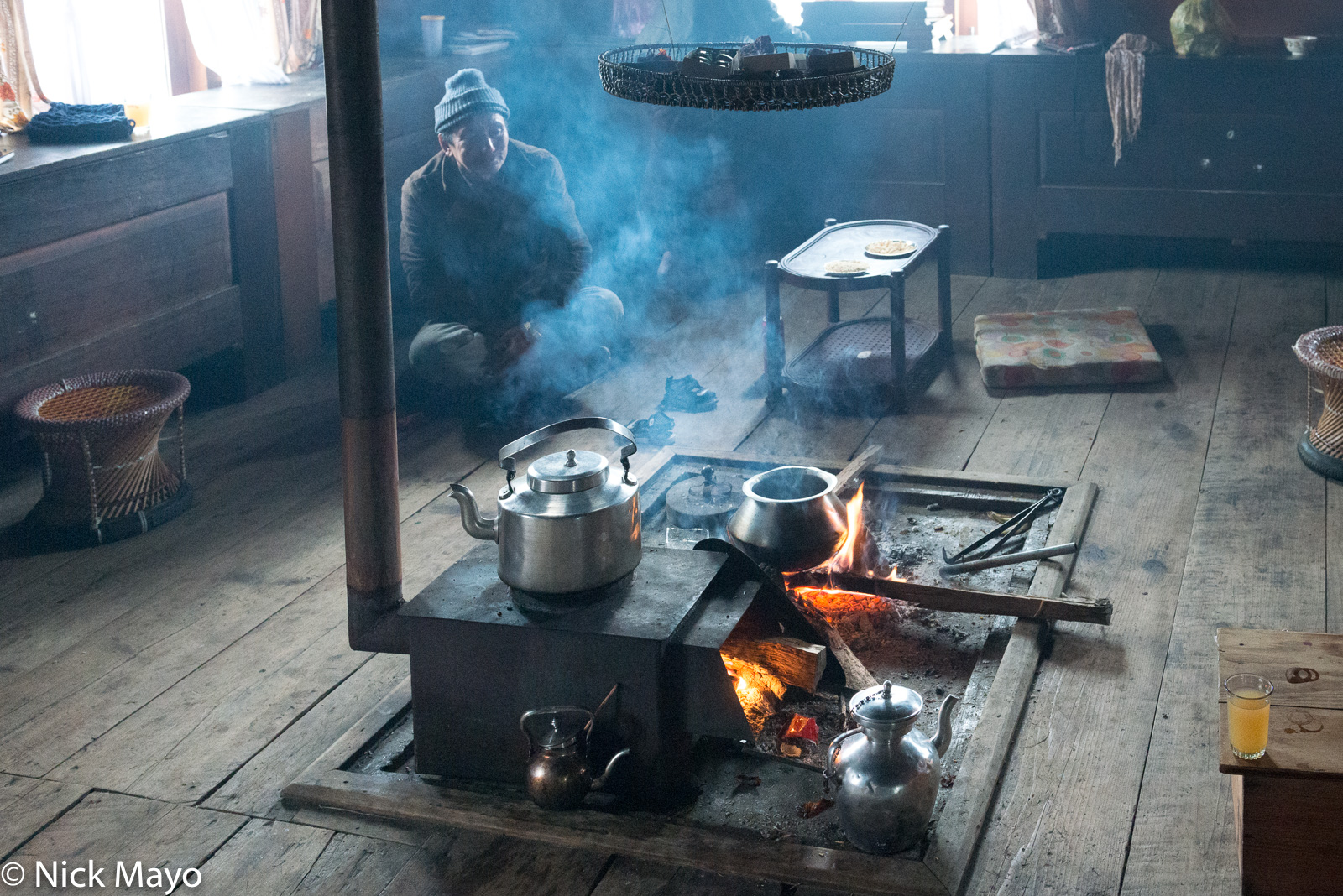 A kettle on an open hearth in a Memba household at Mechukha.