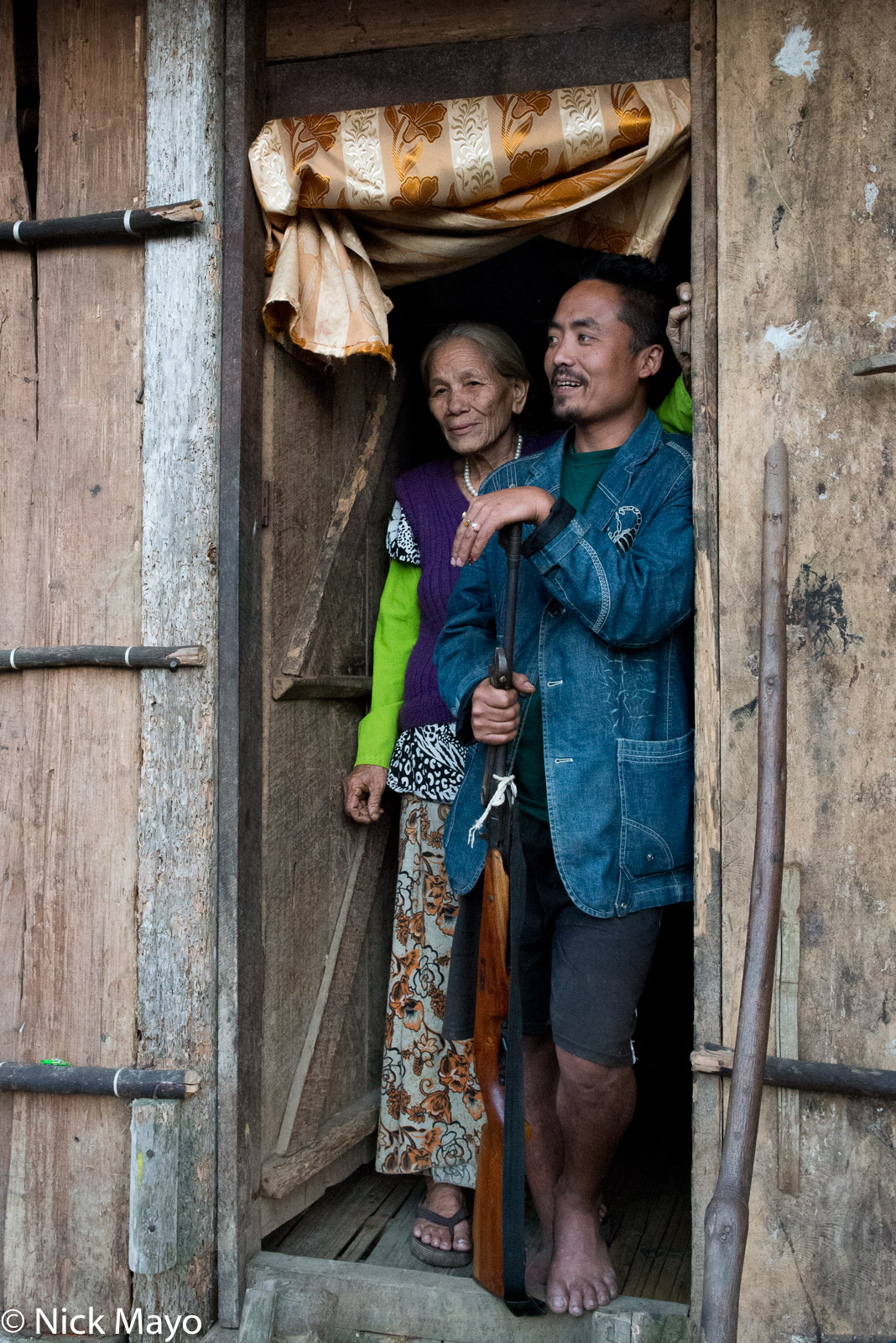 A Galo man with his rifle in the village of Paya.