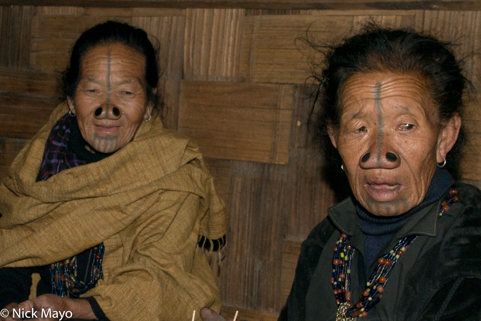 Two tattooed Apatani women with nose plugs at the Myoko festival in Mudang Tage in the Ziro valley.