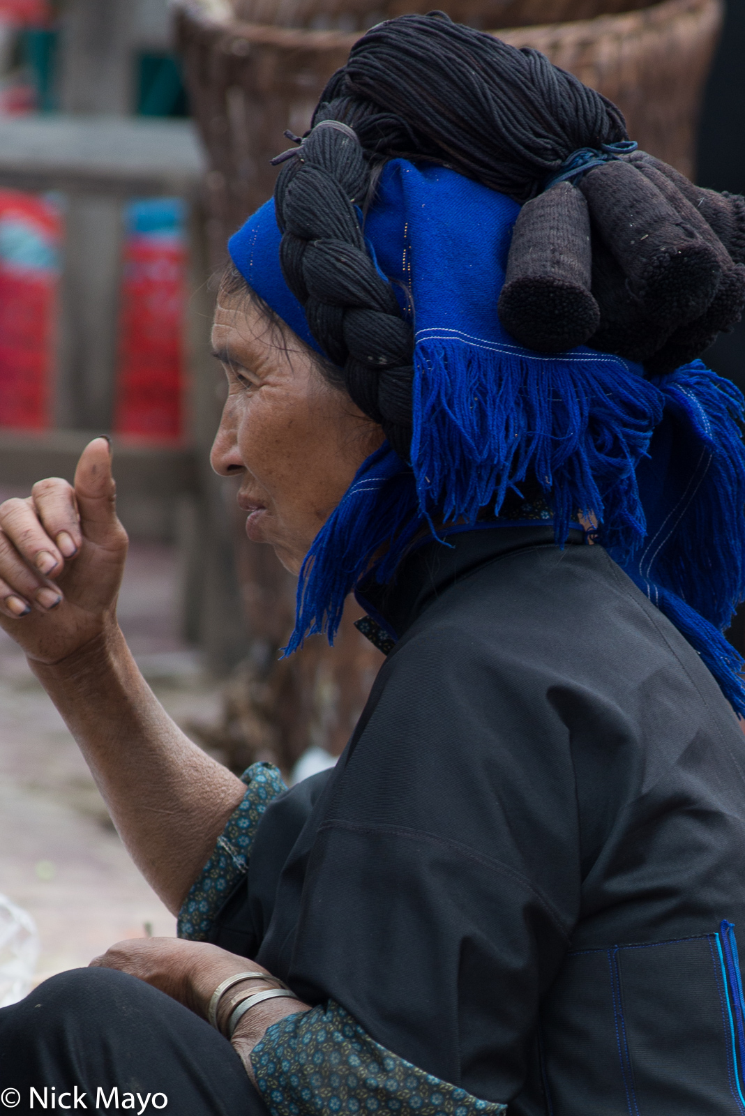 A Black Hani woman with a large fake hairpiece at Y Ty.