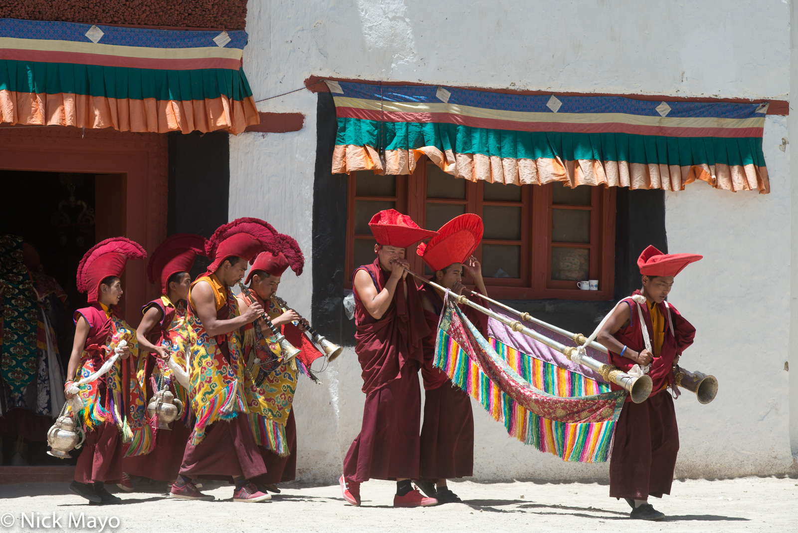 Four monks playing horns followed by two carrying censers at the annual Phyang Tserup.