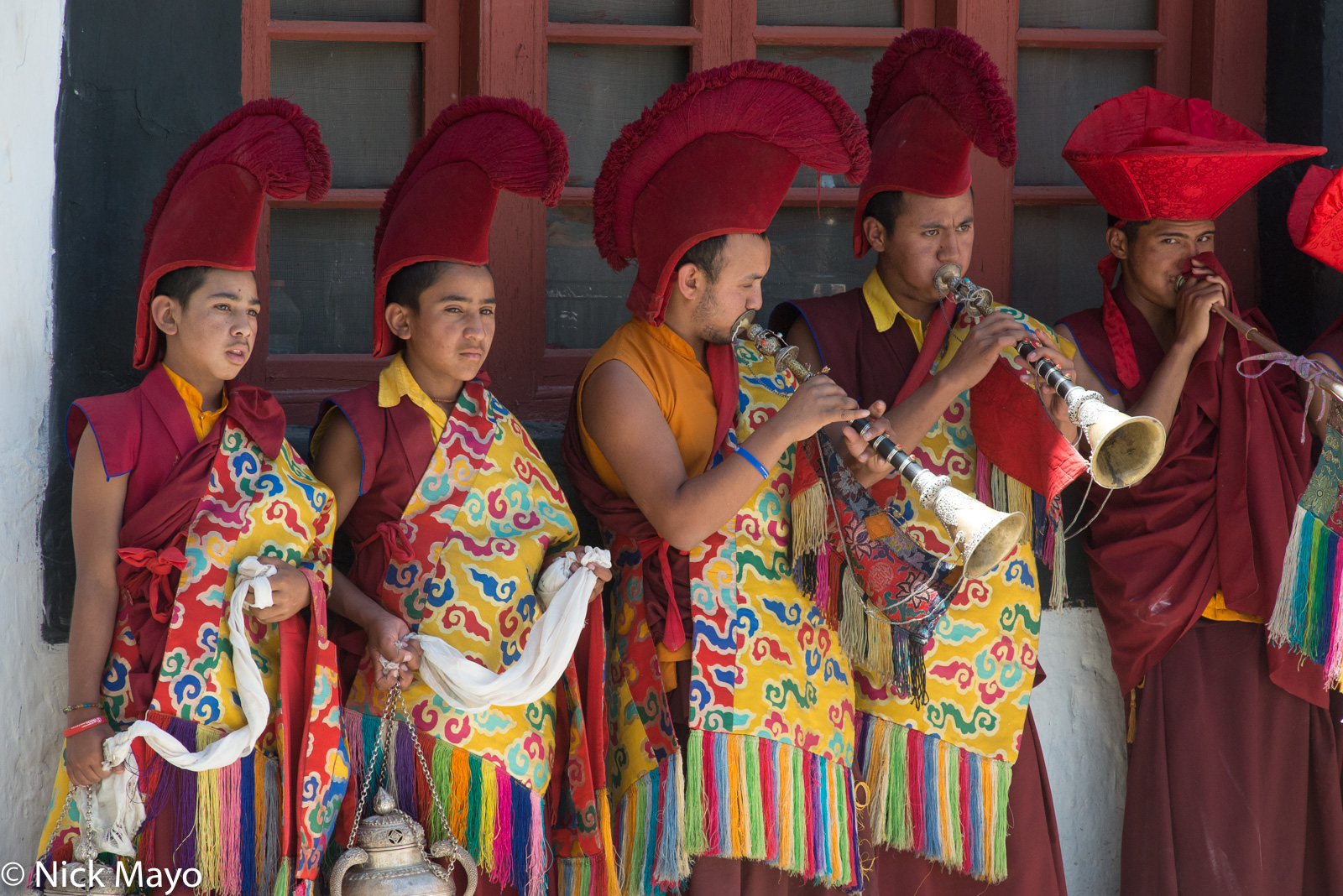 Two monks with censers and three playing horns at the annual Phyang Tserup.