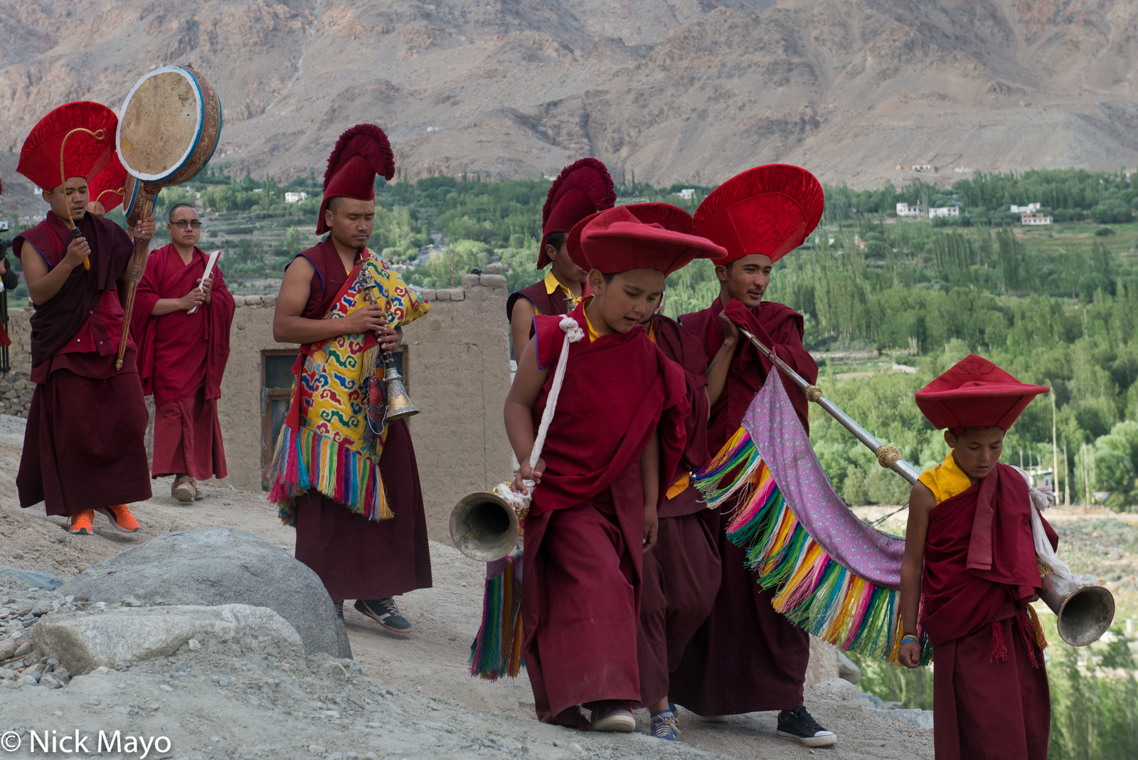Monks with horns and a drum in the closing procession at the annual Phyang Tserup.