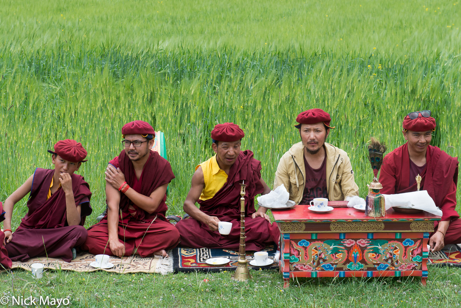 Monks, one with a horn, at a religious ritual to bless the crops in the village of Miru.