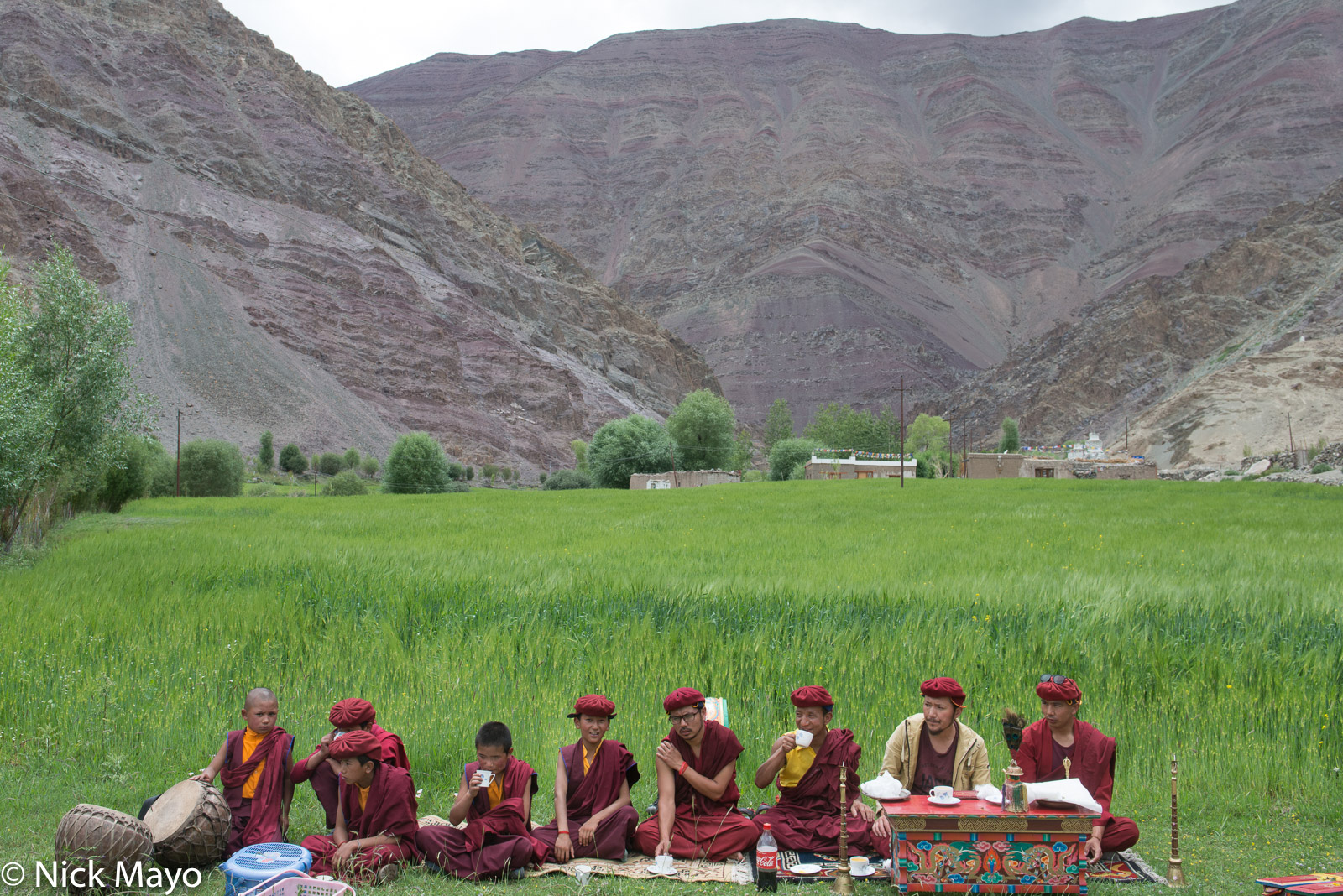 Monks with drums and horns at a religious ritual to bless the crops in the village of Miru.