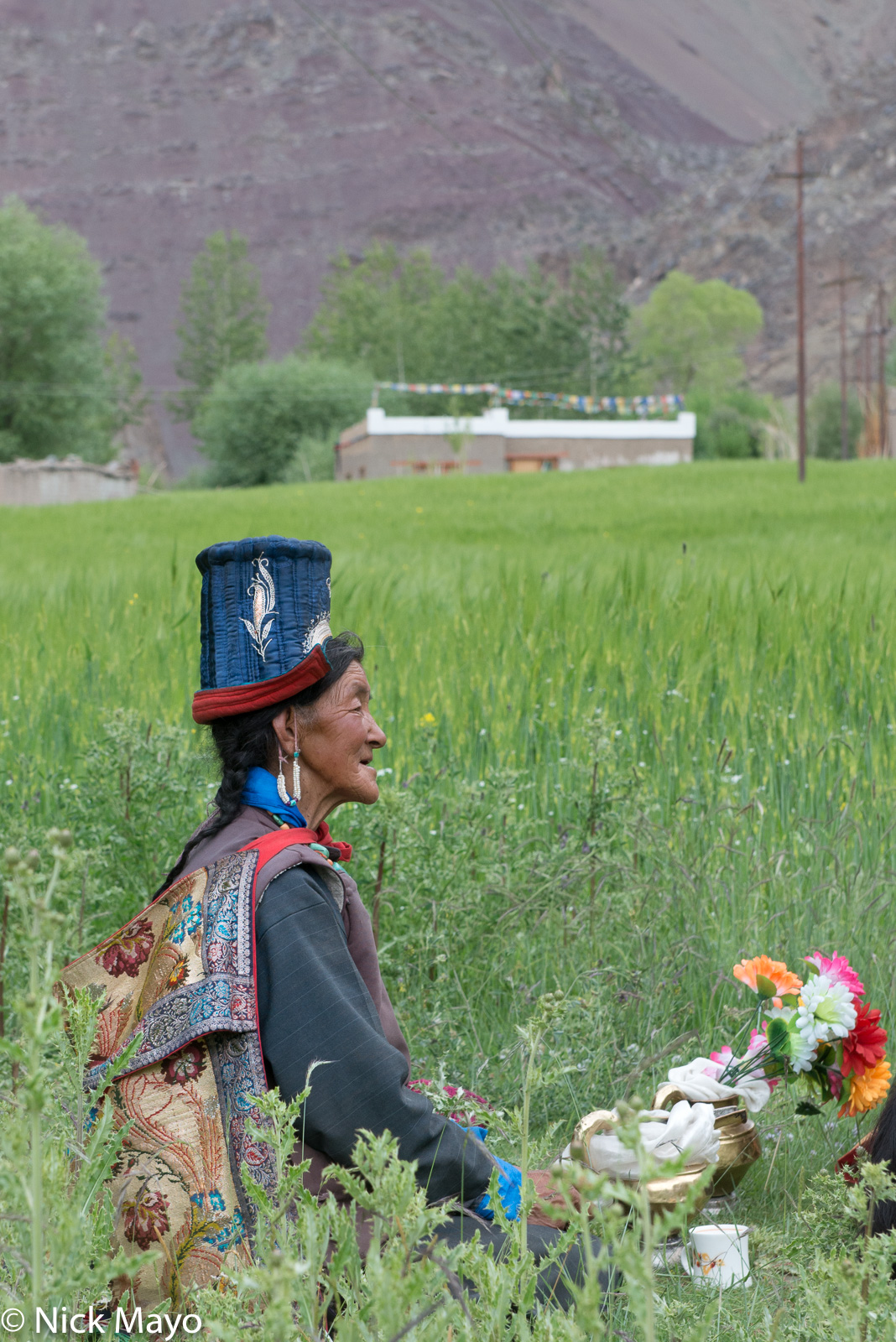 A Ladakhi woman in a traditional tibi hat at a religious ritual in the village of Miru.