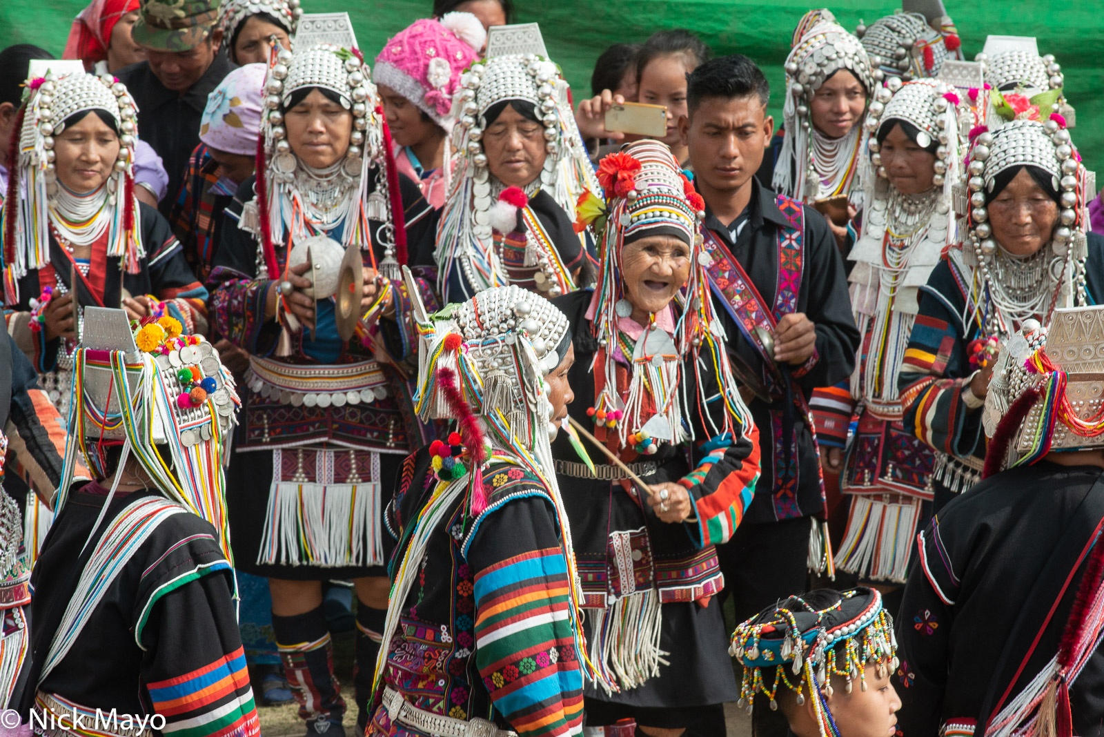 An Ulo Akha (Hani) woman and her Loimi Akha friends, several playing cymbals, at a festival in Kengtung.