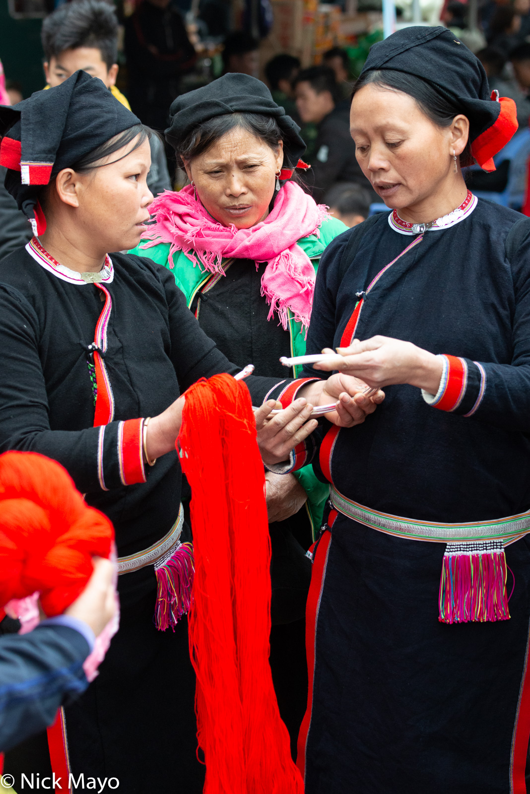 San Chay women shopping for yarn and a necklace at the pre-Tet market in Bao Lac.