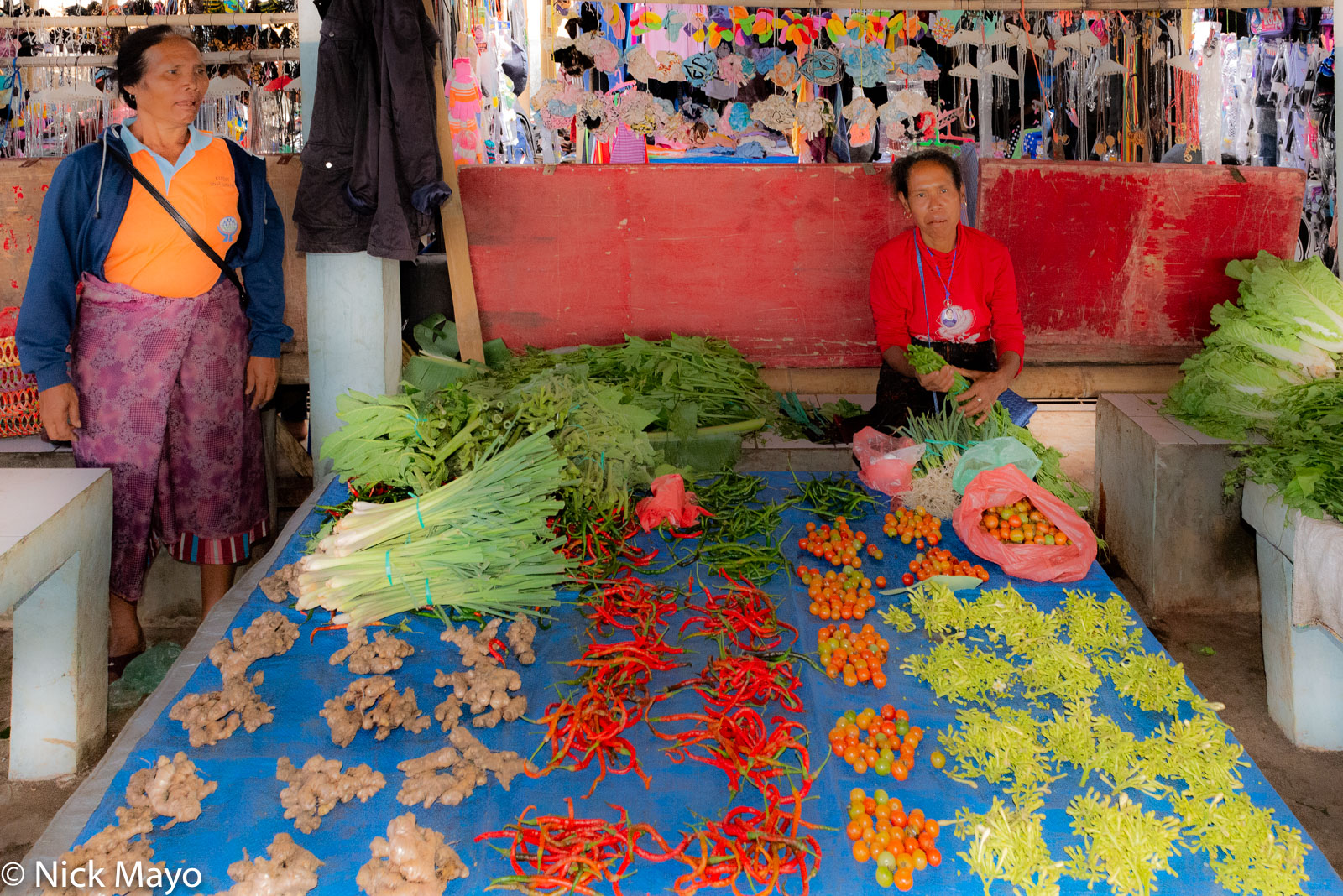 A vendor selling vegetables at Mataloko market in Ngada Regency.