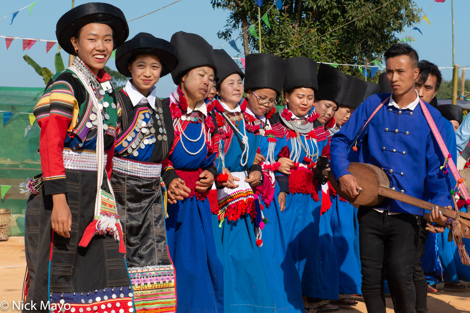 Lisu women dancing to the accompaniment of a traditional three stringed lute at their New Year festival in Mogok.