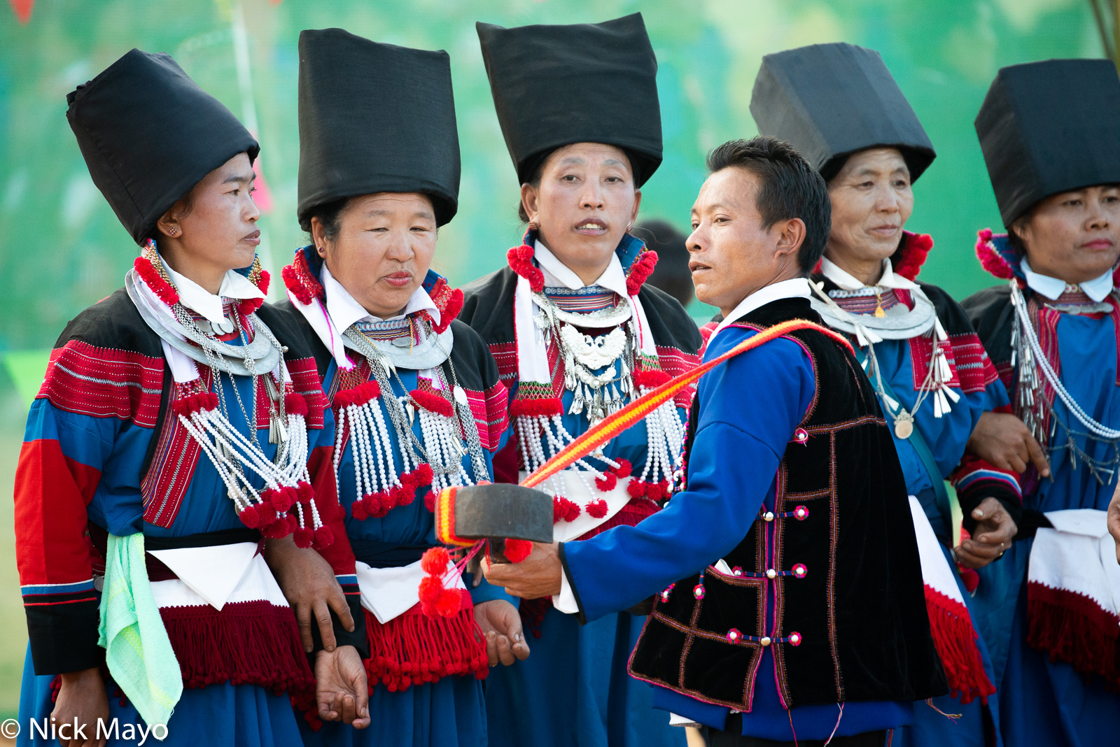 Women dancing to the accompaniment of a traditional three stringed lute at a Lisu New  Year festival in Mogok.