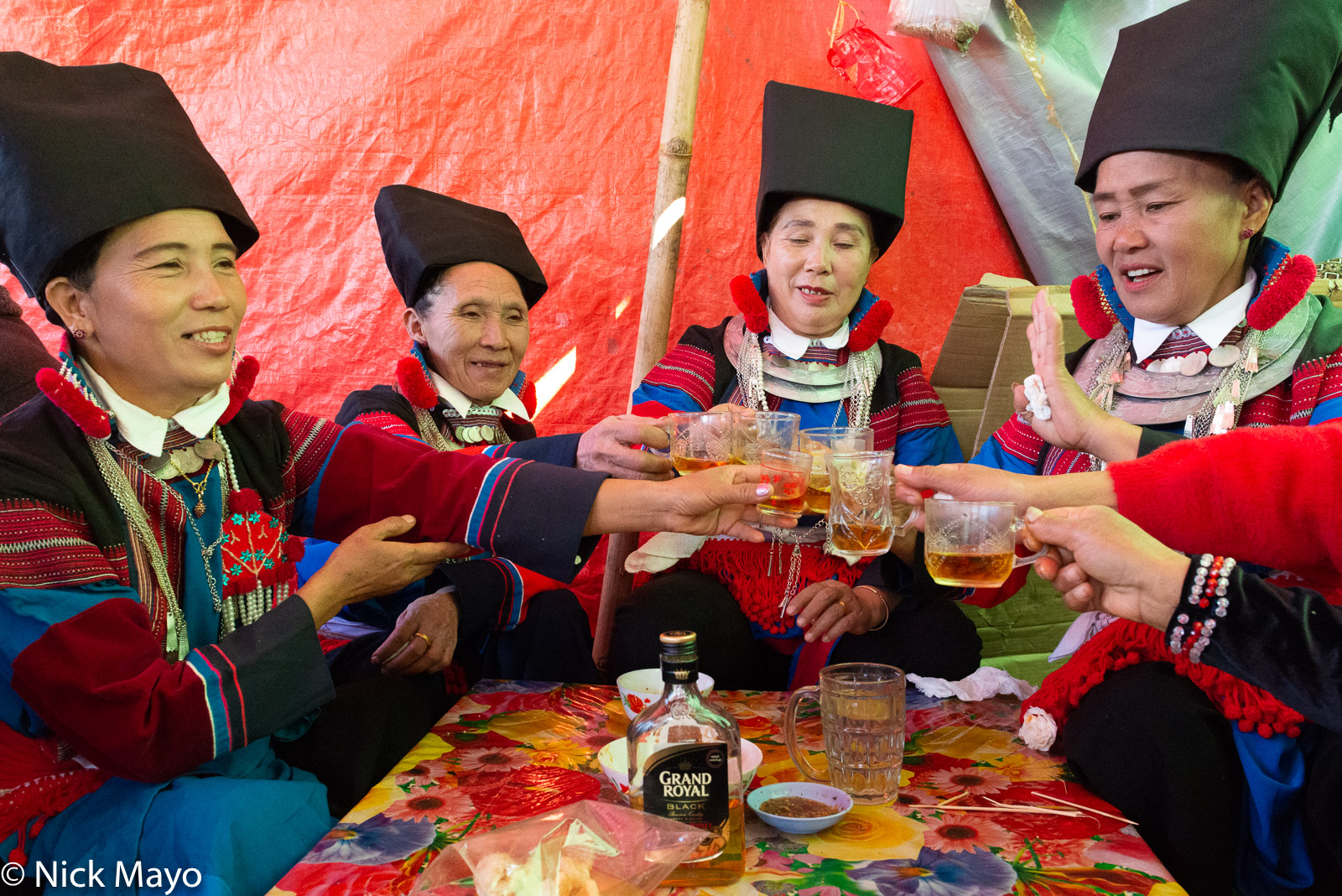 Lisu women drinking whisky at lunchtime at their New Year festival in Mogok.