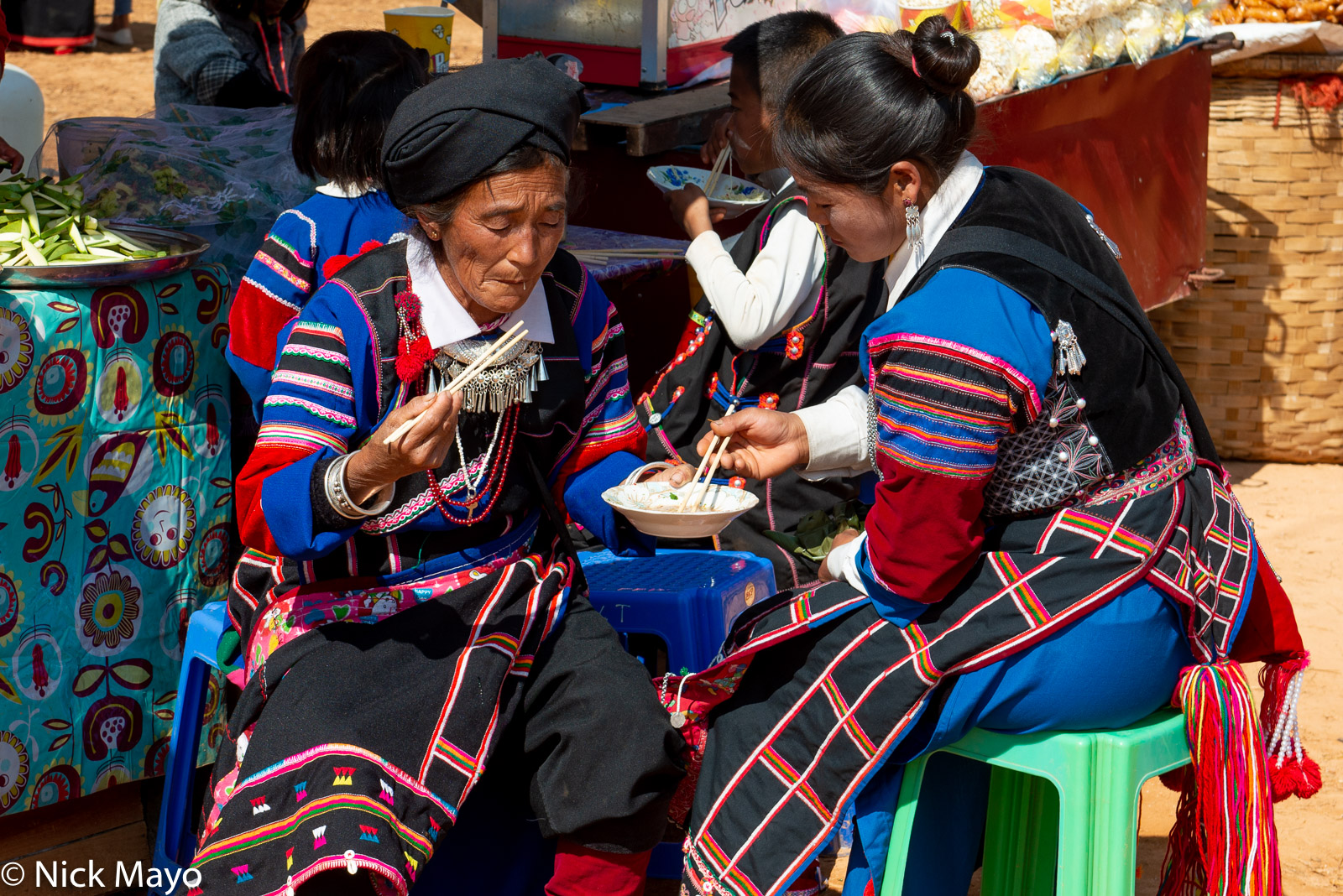 Lisu women eating noodles for breakfast at their New Year festival in Mogok.