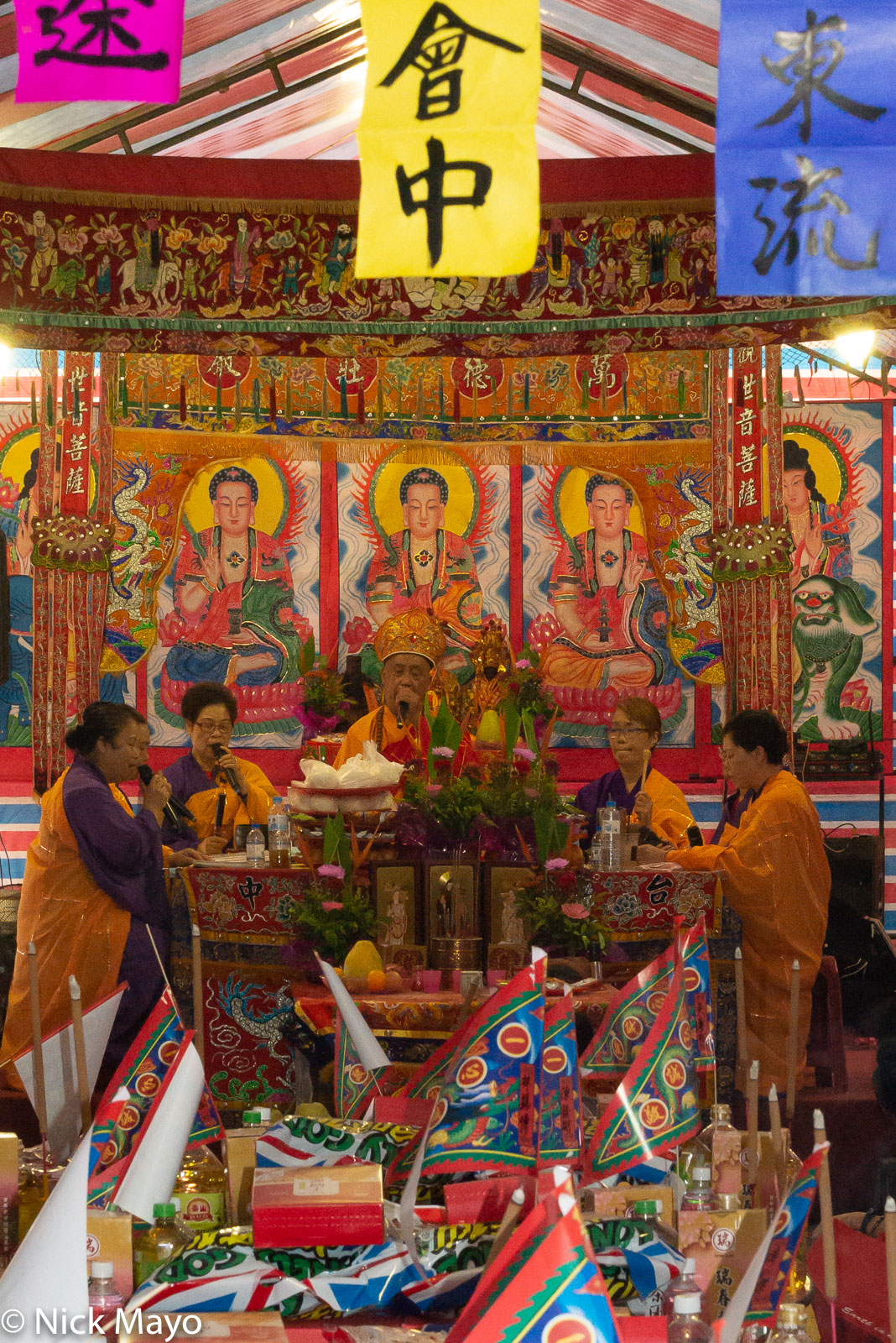 A Taoist priest and faithful chanting at a celebration for a god at a Taichung temple.