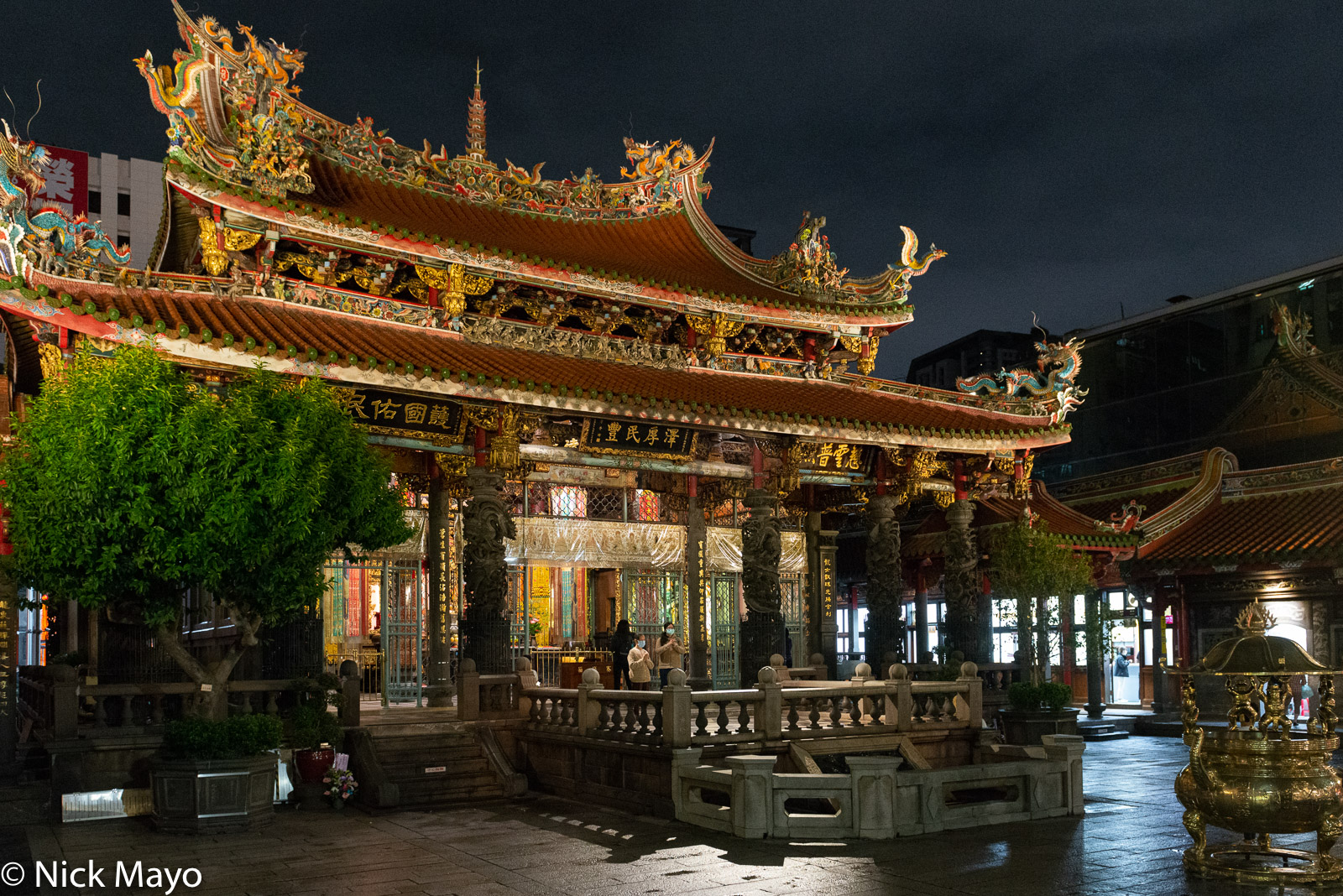 A night view of the Lungshan temple with its ornate roof in the Wanhua district of Taipei.