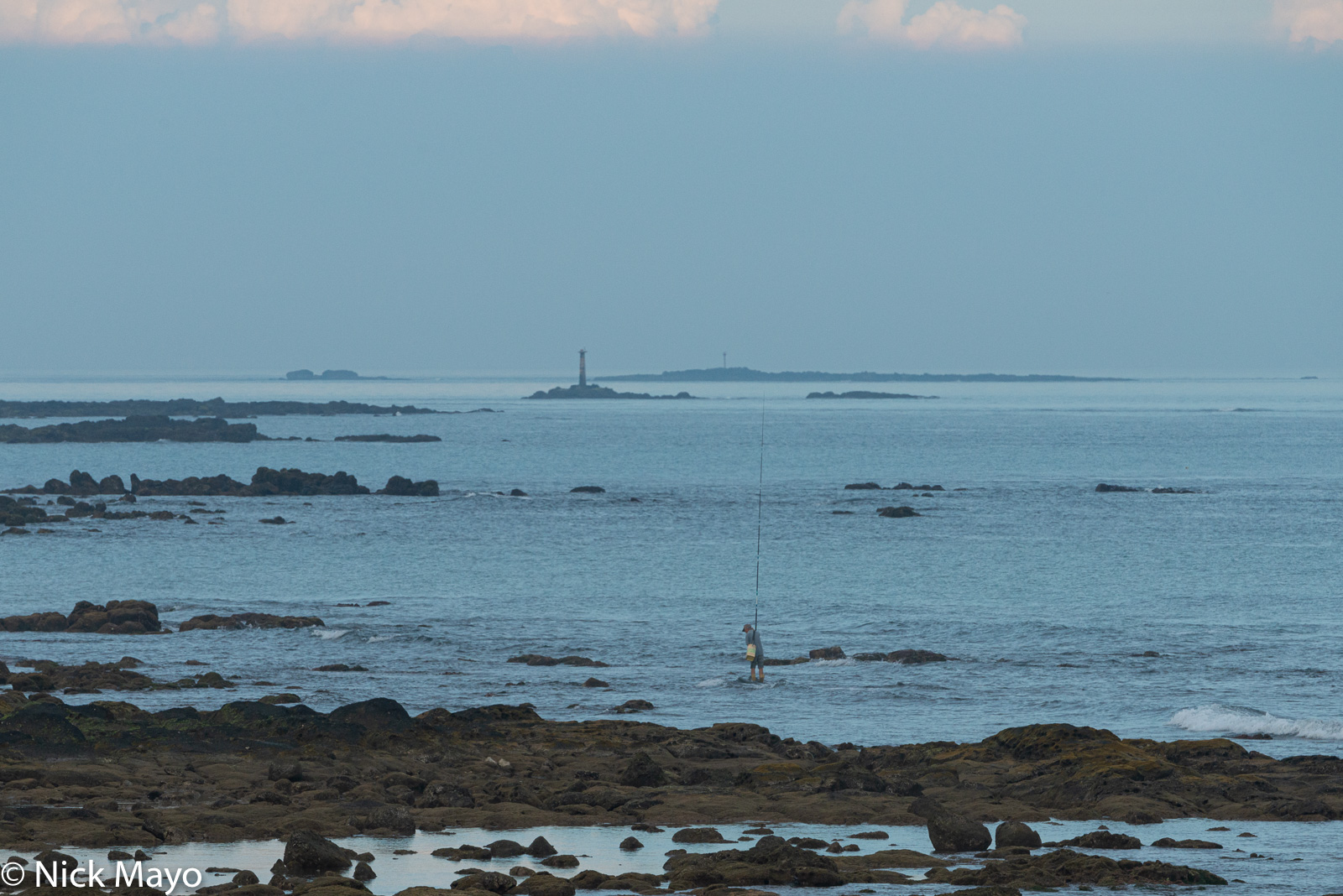 A fisherman searching for the best position on Wangan's coast.