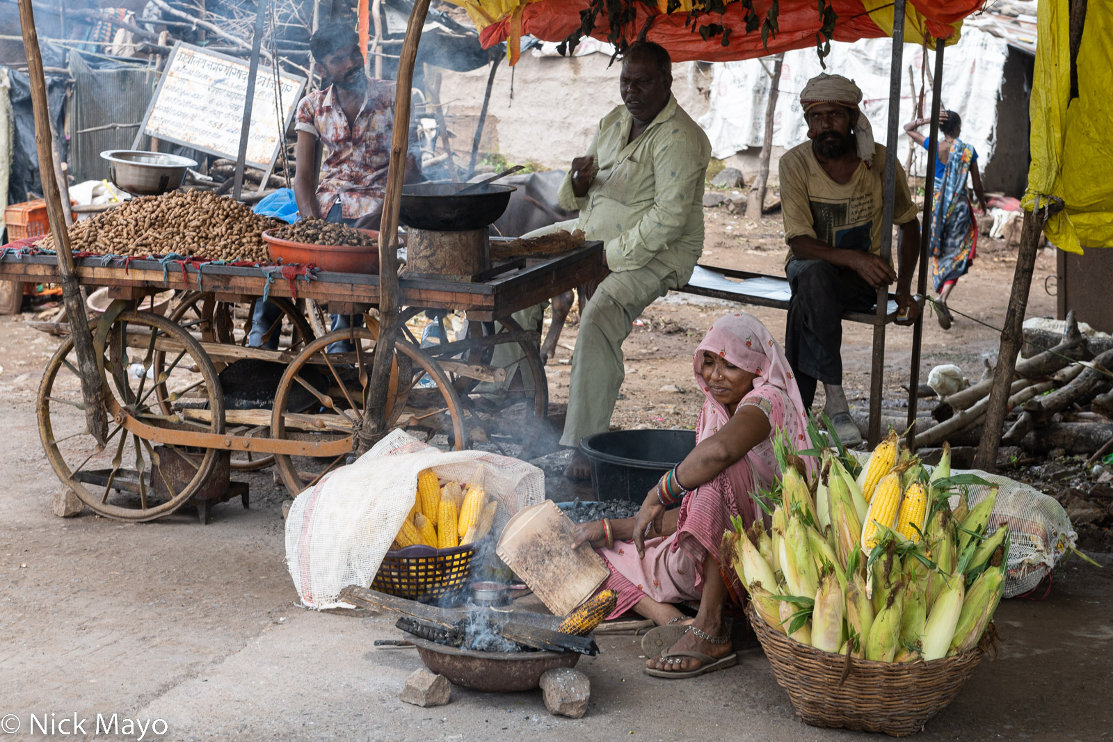 A street vendor roasting a corn cob in Mandu.