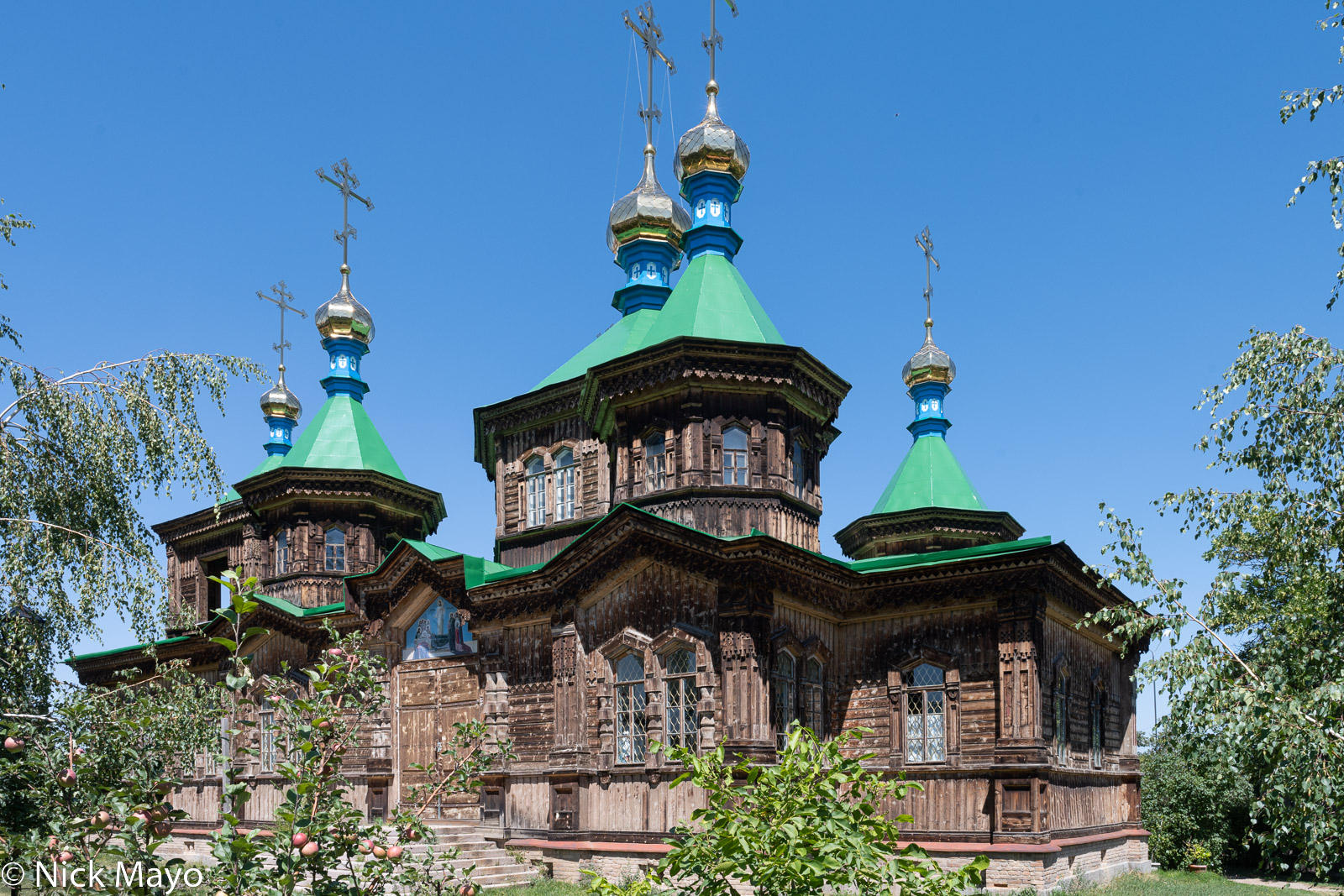 The wooden Russian Orthodox Church Of The Holy Trinity at Karakol with it's roof top towers crowned by gold "onion domes".