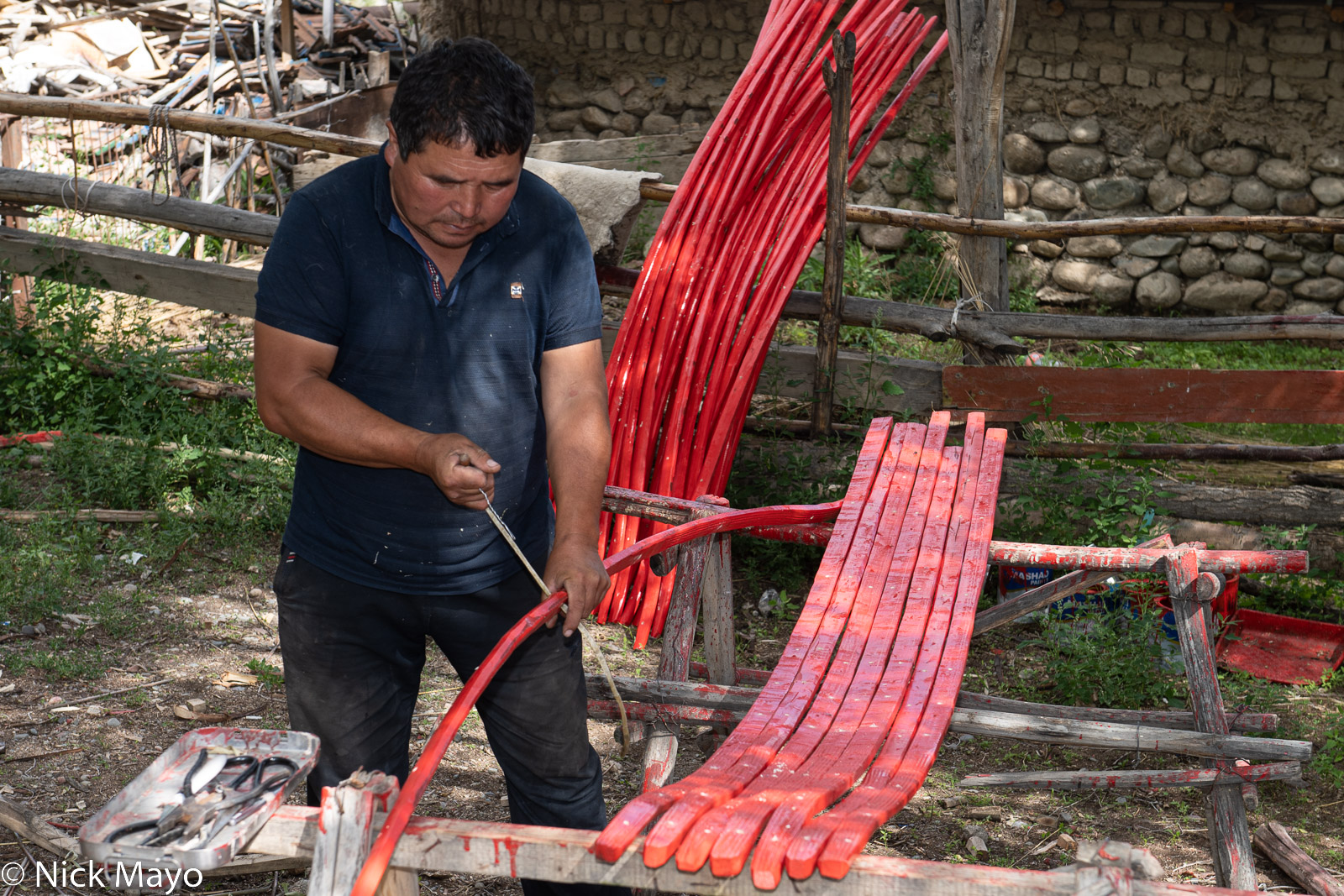A yurt maker fashioning a frame at Kyzul Tuu.