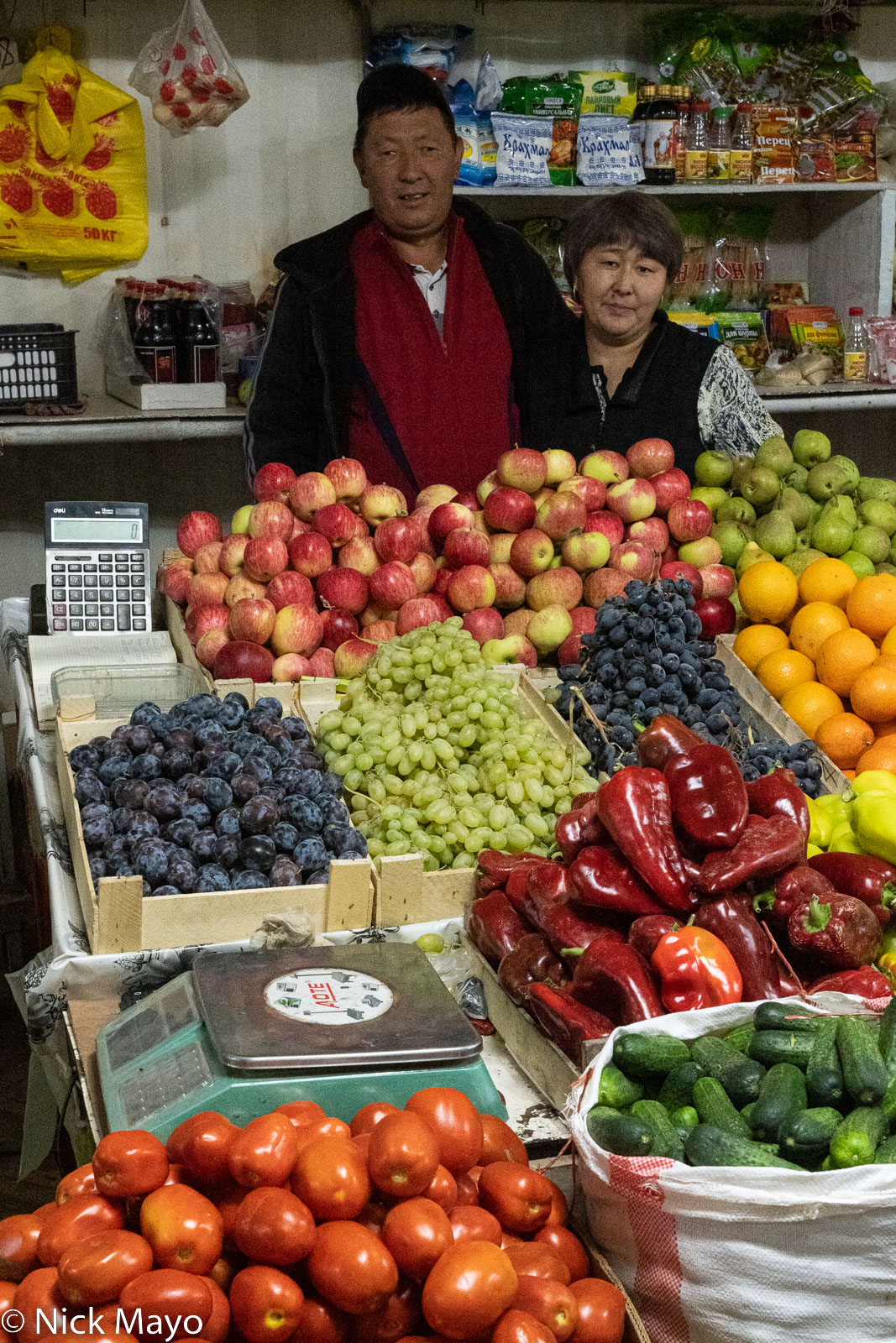 The owners with their vegetable and fruit stand in Naryn market.