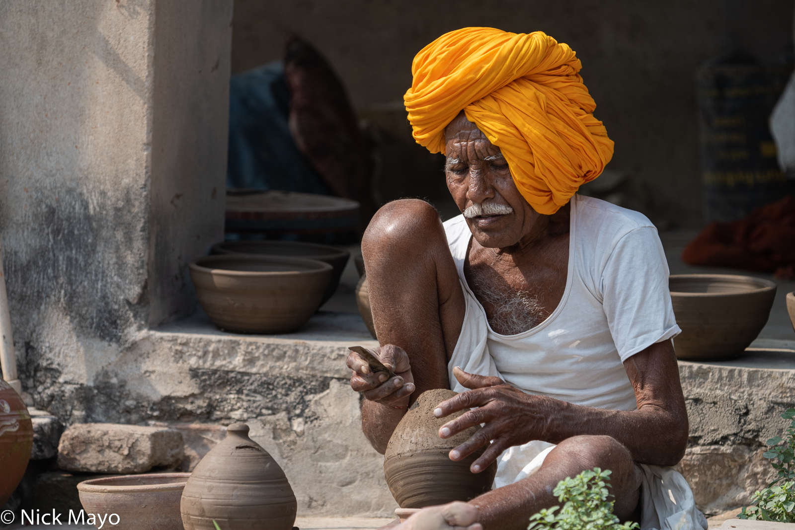 A potter of the Kumhar caste at work in the village of Thikarda.