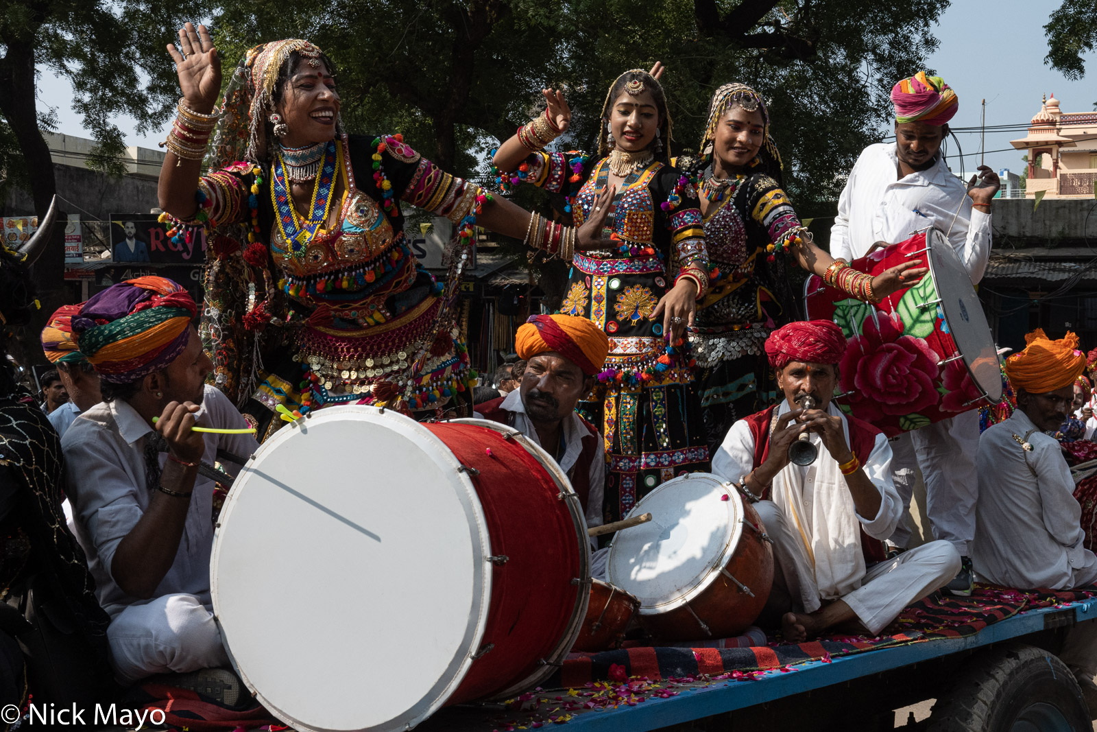 Kalbelia dancers with attendant drummers and a piper on a float at the Bundi Festival.