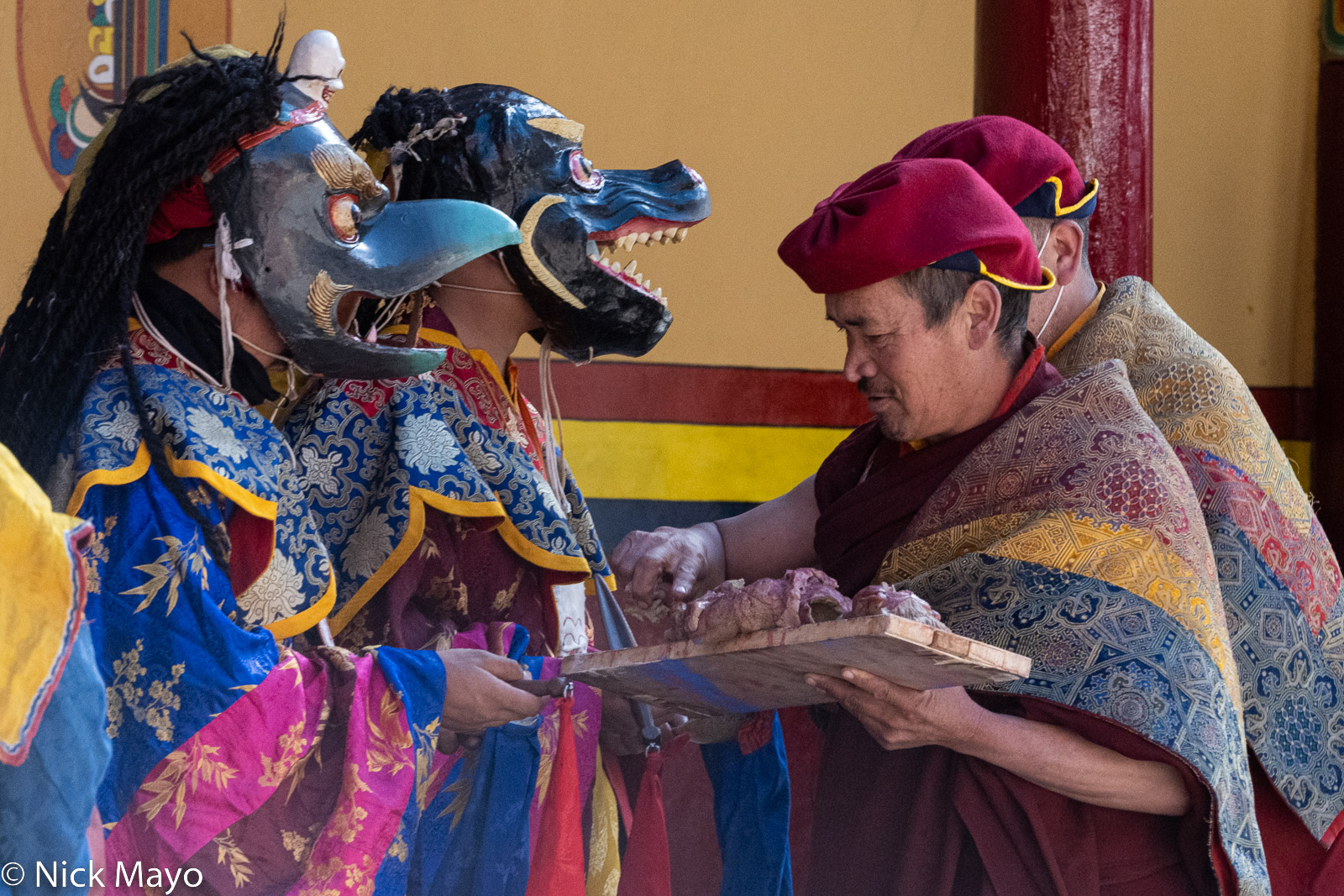 The sacred clay effigy being divided into small pieces to monks participating in the winrer festival at Hemis monastery.