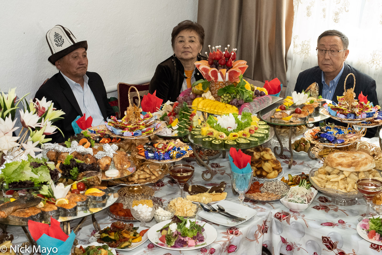 Guests at a wedding meal in the village of Tolok.